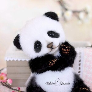 May include: A plush panda bear with black and white fur, featuring black ears, eyes, and paws. The panda has a friendly expression and is holding its paws up. The text "With love Lastenka" is printed on the panda's belly.