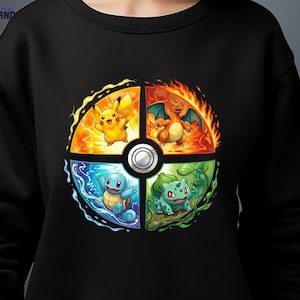 May include: Black sweatshirt featuring a colorful graphic of four Pokémon characters: Pikachu, Charizard, Squirtle, and Bulbasaur, arranged in a circular design. The design includes vibrant orange, blue, and green elements, with a silver button in the center.