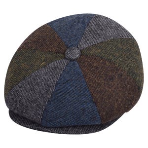 May include: A multi-coloured newsboy cap with a patchwork design. The cap is made from tweed-like fabric in shades of blue, brown, green, and grey. It has a button detail on top and a curved brim, ideal for autumn or winter.