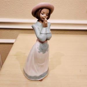 LLadro Nao Porcelain Figurine titled “Please Please” No. 1224. made in Spain by LLadro. Marked. 8  inches Tall
