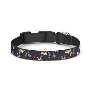 May include: A black pet collar featuring a repeating pattern of dog bones, paw prints, racing flags, and race car graphics in red, yellow, and white. The collar has a black plastic buckle and a metal D-ring.