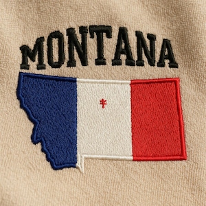 May include: Embroidered patch with the word "MONTANA" in black above a Montana flag design. The flag is a stylized map shape with blue, white, and red stripes, and a small red asterisk.