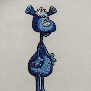 May include: Embroidered patch featuring a whimsical blue cartoon character with large ears, a bulbous body, and long legs. The character is in shades of blue with white accents, stitched on a white background. The design has a playful, cartoonish style.