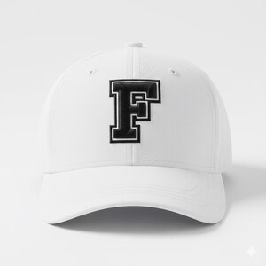 May include: White baseball cap with a black and white embroidered letter "F" on the front. The cap has a curved brim and a button on top. The letter "F" is in a collegiate style.