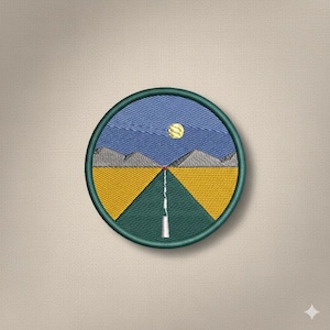 May include: Embroidered patch depicting a landscape scene. The design shows a road leading to the horizon, with yellow fields on either side, under a blue sky with a yellow sun. Grey mountains are in the background, within a green circular border.