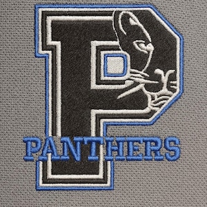 May include: Embroidered patch with the word "PANTHERS" in blue, above a black "P" with a panther head silhouette. The patch has a blue and white border, set against a grey background.