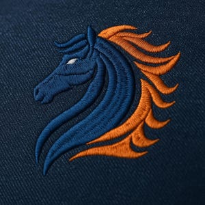 May include: Embroidered horse head design in navy blue and orange on a navy blue fabric. The horse's head is in profile, with a flowing mane. The design is detailed and appears to be stitched.