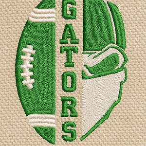 May include: Embroidered design featuring a green football and a helmet, with the word "GATORS" vertically down the center. The design is on a tan fabric background. The football has white stripes.