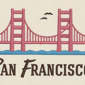 Puede incluir: Parche bordado con el Golden Gate Bridge en rosa, con agua azul y dos pájaros negros. El texto "SAN FRANCISCO" está en fuente marrón, ideal para recuerdos de viaje.