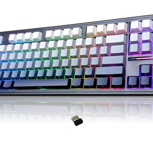 May include: A black and grey mechanical keyboard with white and grey keycaps. The keyboard has multi-coloured LED backlighting. A small USB receiver is in front of the keyboard.