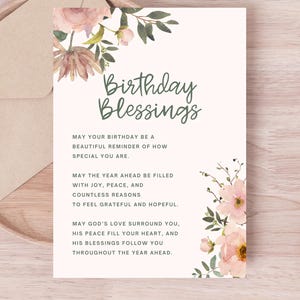 May include: A birthday greeting card with the words "Birthday Blessings" in green script. The card features floral accents in pink and green, and is accompanied by a beige envelope. The card's message is a heartfelt birthday wish.