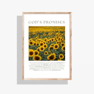 May include: A framed print featuring a field of sunflowers in full bloom. The print has the text "GOD'S PROMISES" at the top, with Bible verses below. The frame is a light brown color, and the print is rectangular.