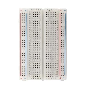 May include: A white breadboard with rows of holes for electronics projects. The board has labeled columns and rows, with red and blue lines indicating power rails. The breadboard is a useful tool for prototyping circuits.
