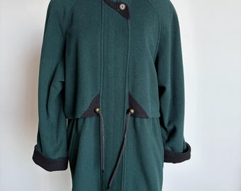 May include: A dark green coat with a black collar and cuffs. The coat has a zipper closure and a drawstring waist. It features black accents and gold-colored button details. The coat is displayed on a mannequin.