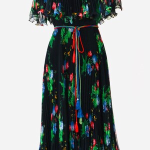 May include: A black pleated dress with a floral print and a colorful tassel tie belt. The dress has short, ruffled sleeves and a flowing skirt.