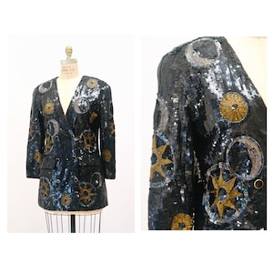 May include: A black sequined jacket with gold and blue celestial embroidery. The jacket features moons, stars, and suns.