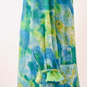 May include: A blue and green floral print dress with a ruffled sleeve detail.