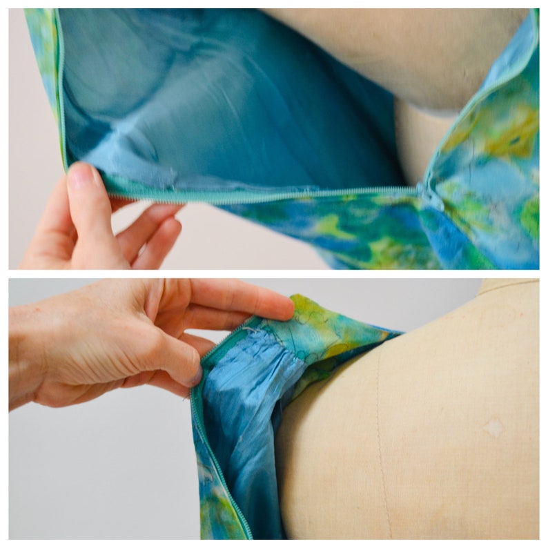 May include: Close-up of a blue and green patterned dress with a zipper closure. The zipper is partially open, revealing the lining of the dress.