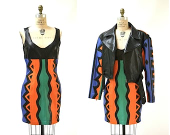 May include: A black leather jacket with blue and orange geometric patterned sleeves and a matching mini dress with a black leather bodice.