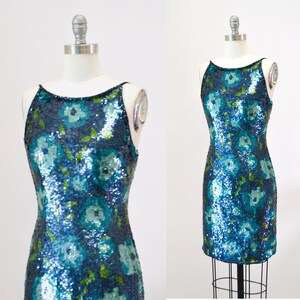May include: A sleeveless sequined dress with a floral pattern in shades of blue and green.