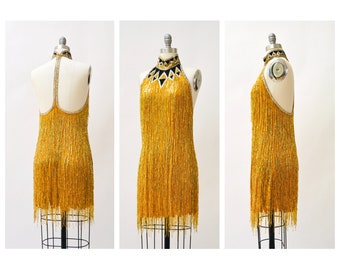 roberto cavalli gold fringe dress Vintage Roberto Cavalli Class gold knit dress with fringe detailing. Best fit sizes S-M due to stretch. $550