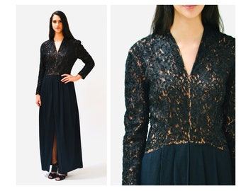 May include: A long black lace dress with a V-neckline and long sleeves. The dress has a fitted bodice and a flowing skirt.