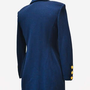 May include: A navy blue blazer with gold star buttons on the sleeves.