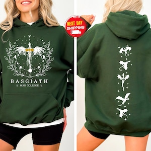 May include: Dark green hoodie with a front graphic featuring a dragon design, the text "BASGIATH WAR COLLEGE", and a back graphic with several dragon silhouettes. The hoodie has a hood and a front pocket.