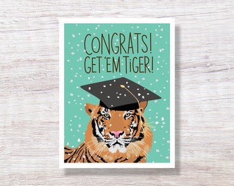 May include: A graduation card with a tiger wearing a graduation cap. The card has a teal background with white confetti and the text "Congrats! Get 'em Tiger!"