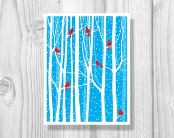 May include: A winter scene with a blue background and white trees. Red cardinals are perched on the branches of the trees. The background is covered in white dots, resembling snow.