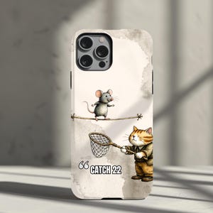 May include: A white ceramic mug with a black handle and the text "But First, Coffee" in a bold, black font. The mug is set against a blurred background, suggesting a cosy setting.