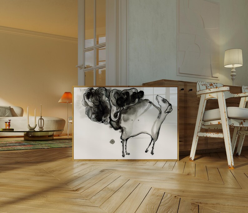May include: A rectangular framed wall art piece featuring a black and white ink wash illustration of a stylized animal figure with a large, swirling cloud-like mass extending from its back, set against a plain white background within a wooden frame.