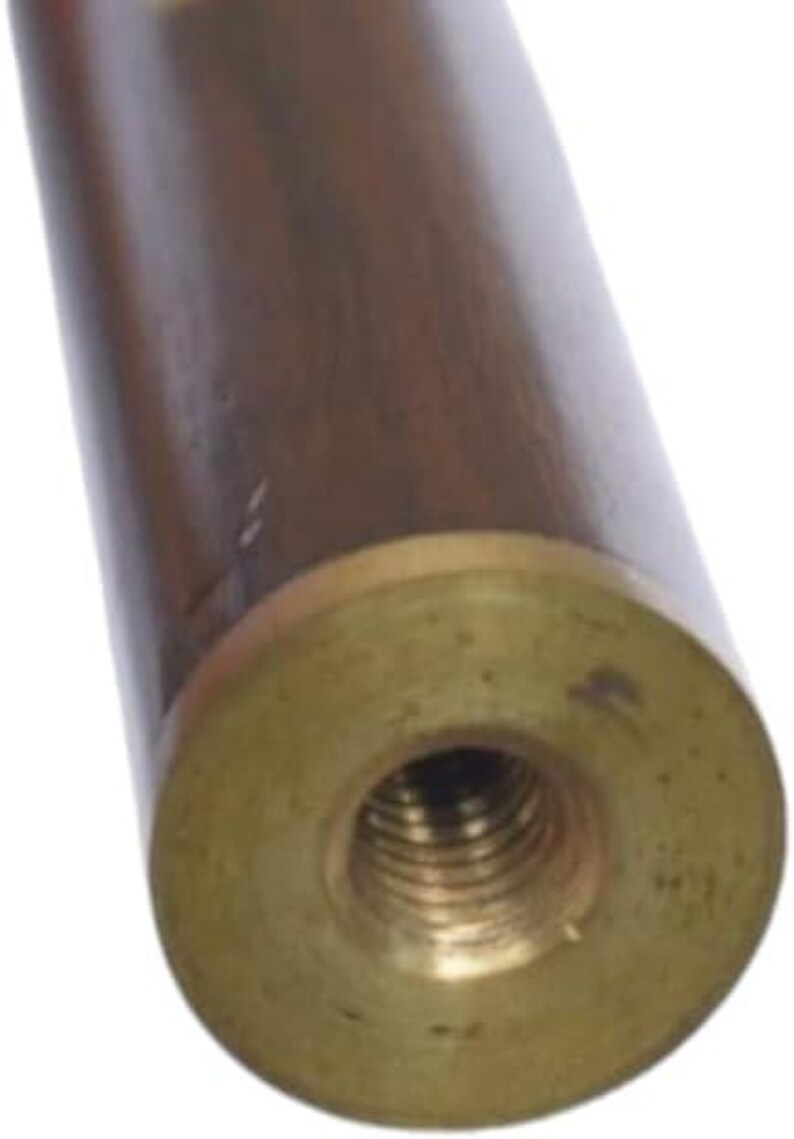 May include: Close-up of a wooden object with a brass fitting. The cylindrical body is a dark brown color, and the brass fitting has a threaded hole in the center. The object appears to be a component of a larger item.