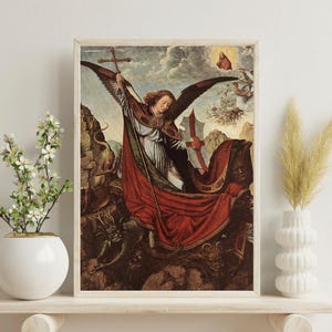 May include: Framed print of a Renaissance-style painting depicting Saint Michael the Archangel. The artwork features a winged figure holding a cross and spear, clad in red and white robes, battling demons. The colour palette includes reds, browns, and blues.