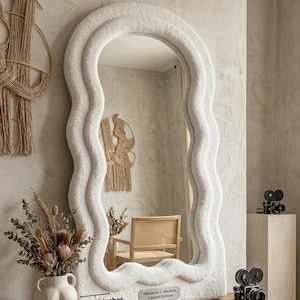 May include: A white, wavy-edged floor mirror with a textured, fuzzy fabric frame. A small metal plaque on the bottom reads 'Miniature Collection - Limited Edition'. A white ruler shows a width of 12 inches and a depth of 6 inches.