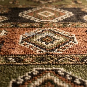 May include: A woven rug featuring a textured pile with a repeating geometric pattern in shades of olive green, burnt orange, and dark brown. The design includes diamond-shaped motifs and small floral-like accents across the surface.