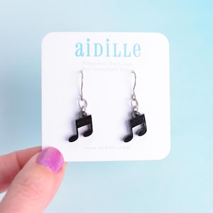 May include: A pair of black music note earrings on a white card with the text "aidille Titanium Earrings for Sensitive Ears www.aidille.com"