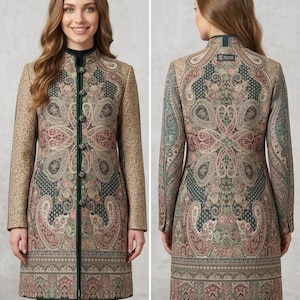 Op de afbeelding: Een lange jas met een paisley patroon in groen, roze en beige tinten. De jas heeft een opstaande kraag, donkergroene bies en een knoopsluiting. De lengte is 99 cm. De tekst "Potly Buttons Details" is zichtbaar.