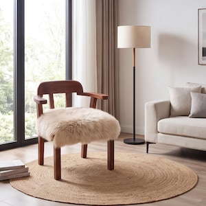 May include: A wooden armchair with a curved backrest and armrests, featuring a thick, plush, light beige faux fur seat cushion. The chair has four straight wooden legs and a natural wood finish, providing a sturdy base for the soft seat.