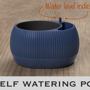 May include: A dark blue self-watering pot with a ribbed exterior texture and a black interior basin. The pot features a small, vertical water level indicator protruding from the top rim. The text "Water level indicator" and "SELF WATERING POT" are visible.
