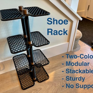 May include: A black and brown shoe rack with multiple shelves. The rack has a modular design and is stackable. The text "Shoe Rack" is visible on the image, along with the words "Two-Color", "Modular", "Stackable", "Sturdy", and "No Supports".
