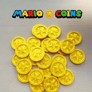 May include: A collection of bright yellow coins with a star design, reminiscent of the Mario video game series. The text "MARIO COINS" is displayed above the coins in colorful letters. These coins are likely used for cosplay or as collectibles.