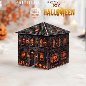 May include: A 3D paper model of a haunted house featuring a dark, textured exterior with glowing orange windows, pumpkins, and tombstones. The roof is decorated with spiderwebs and small pumpkin accents. Text includes PRINTABLE, ARTSVILLE DIY, and HALLOWEEN.