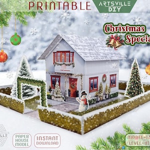May include: A paper house model with a Christmas theme. The white house has red window frames and a red door. The image includes Christmas decorations, a snowman, and the text "Christmas Special!" and "Printable".