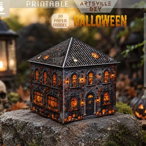 May include: A 3D paper model of a haunted house featuring a dark gray exterior with orange glowing windows, intricate spider web details, and pumpkin decorations. The structure includes a peaked roof and is designed for printing, cutting, and folding.