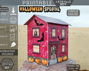 May include: A red paper house with a Halloween theme, featuring a skeleton in the windows and on the porch, with bats and pumpkins. The text "Halloween Special" is displayed on the roof. Includes instructions.