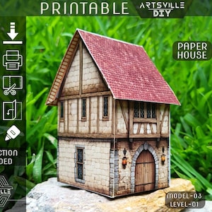 Op de afbeelding: Printbaar papieren huismodel met een rood pannendak, stenen muren en houten balken. Het model heeft een gedetailleerde gevel met ramen en een houten deur. De afbeelding bevat de tekst "Printable", "Artsville DIY" en "Paper House". Model-03, Level-01.