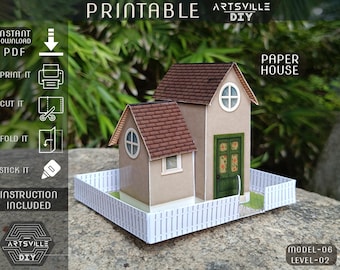 May include: A paper house model with a brown roof, beige walls, and a white picket fence. The house has a green door and round windows. The image includes the text "Printable" and "Paper House".