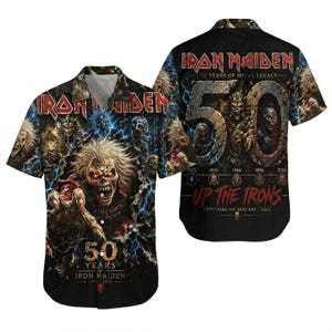 May include: A black short-sleeved button-down shirt featuring Iron Maiden graphics. The front displays a detailed creature with glowing eyes and the text 50 YEARS OF IRON MAIDEN 1975-2025. The back shows a large 50 with skulls and UP THE IRONS text.