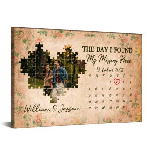 May include: A personalized canvas print featuring a couple's photo within a puzzle piece design. The text reads "The Day I Found My Missing Piece" with the date October 2025 and a calendar highlighting a specific date. Floral accents and names are also included.
